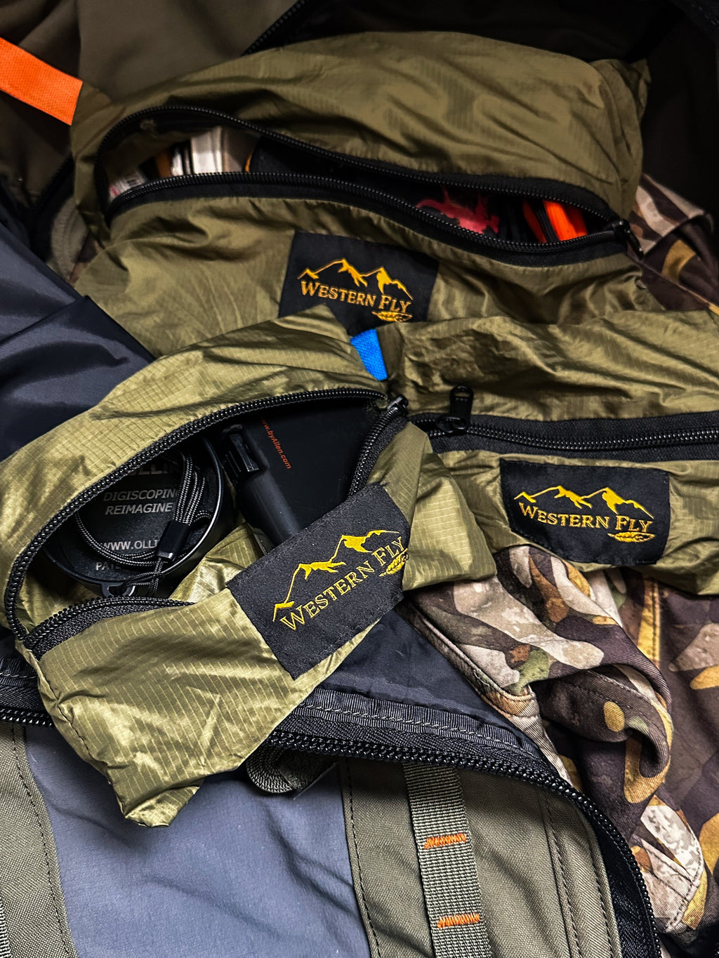 Close-up of a backpack with multiple Western Fly packs and visible branding.