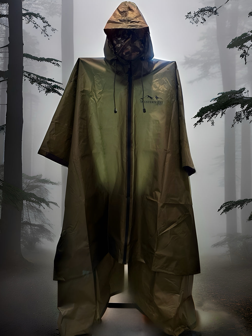 Person wearing a green Western Fly poncho with a hood in a foggy forest setting