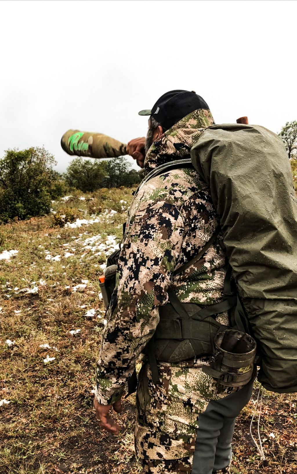 Hunter in camo with olive green Western Fly pack fly in an outdoor setting