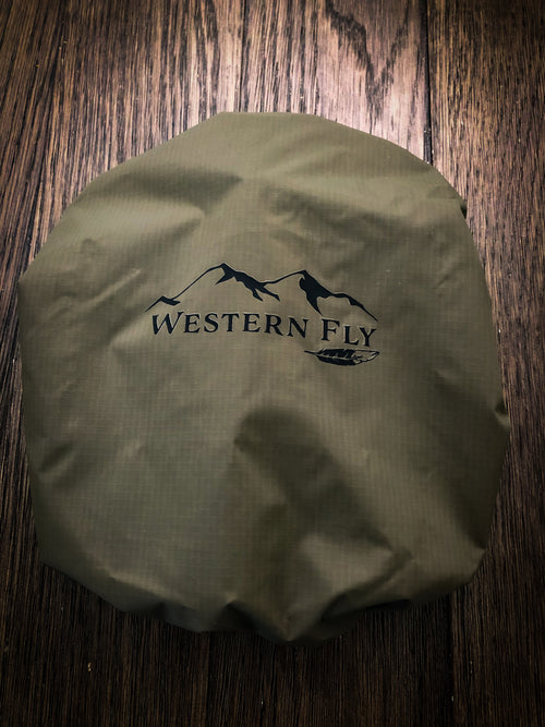 Olive drab bino fly with 'Western Fly' logo on a wooden surface